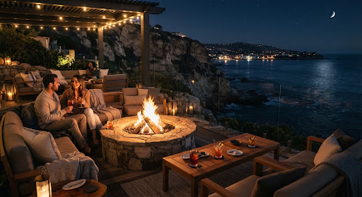 Fire pit cliffside lounge with night lighting and cocktails